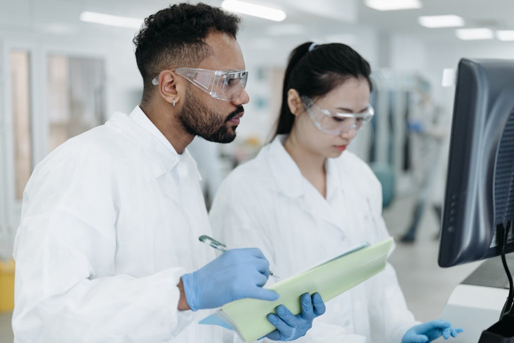 Two scientists conducting research together in a modern lab environment.